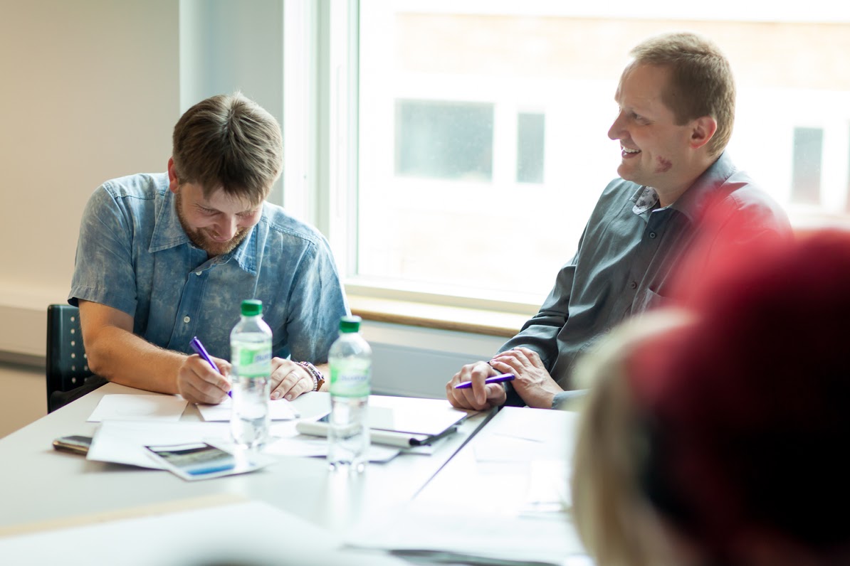 Partners writing during workshop