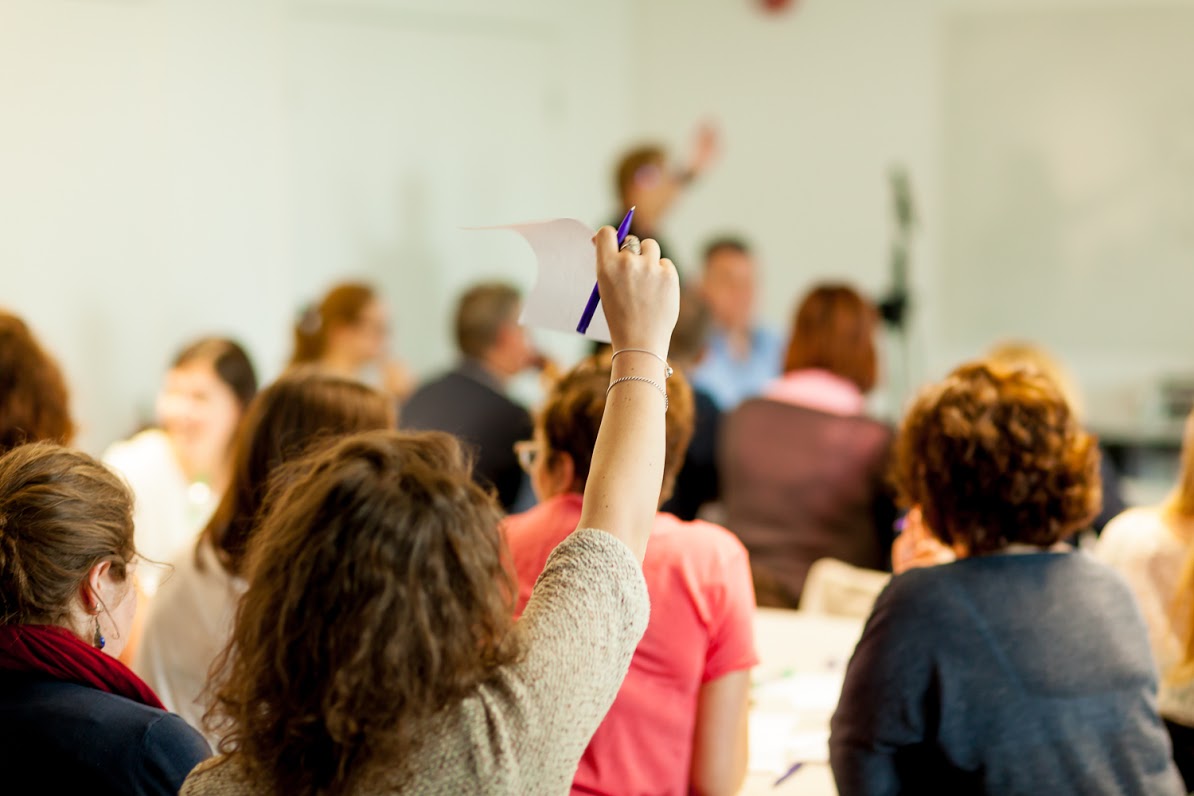 Partner raising hand during workshop