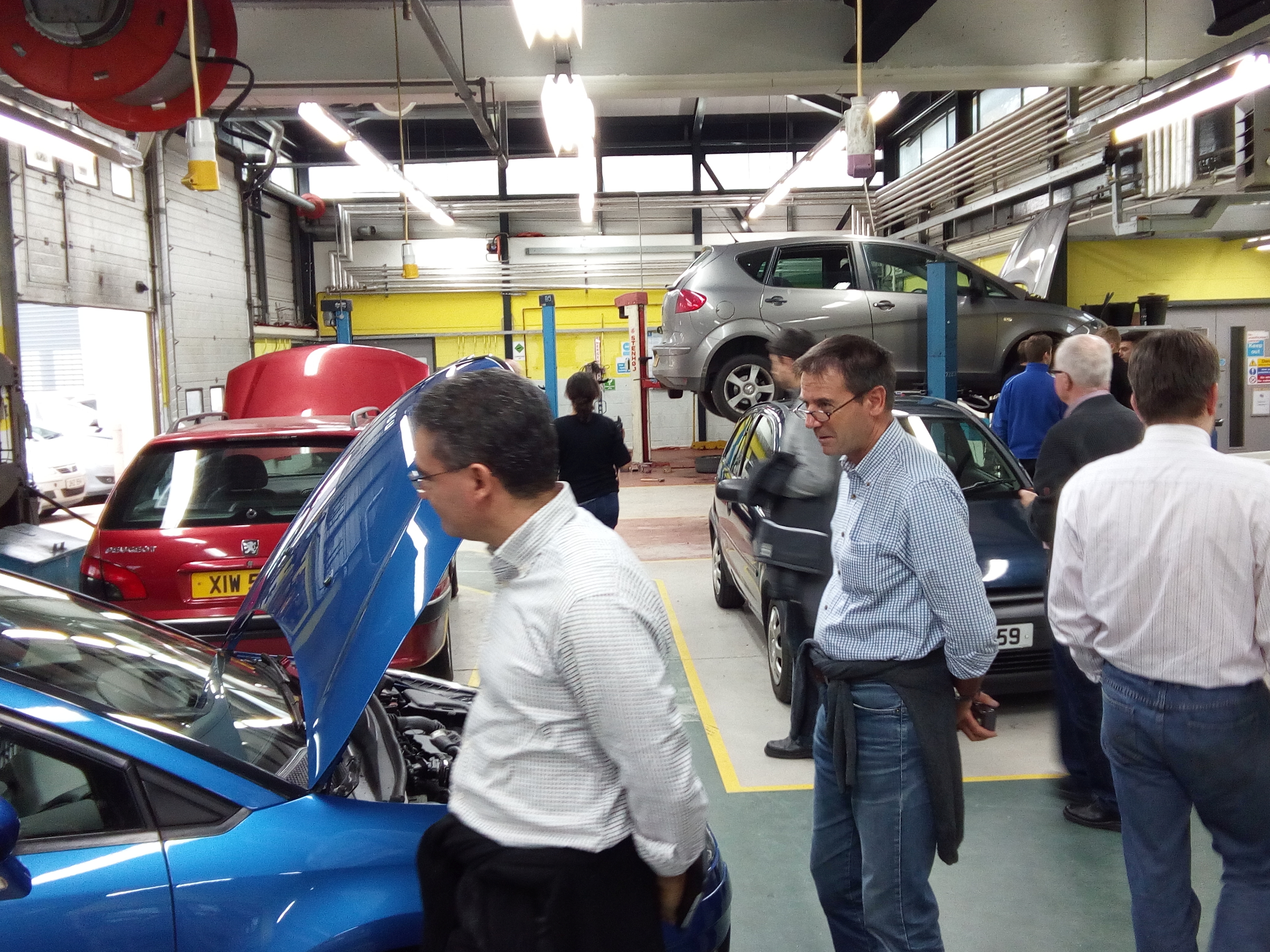 Partners looking at cars in garage