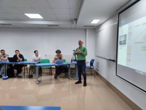 Man next to whiteboard giving presentation