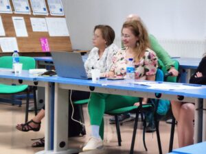 2 women sat at desks with laptops