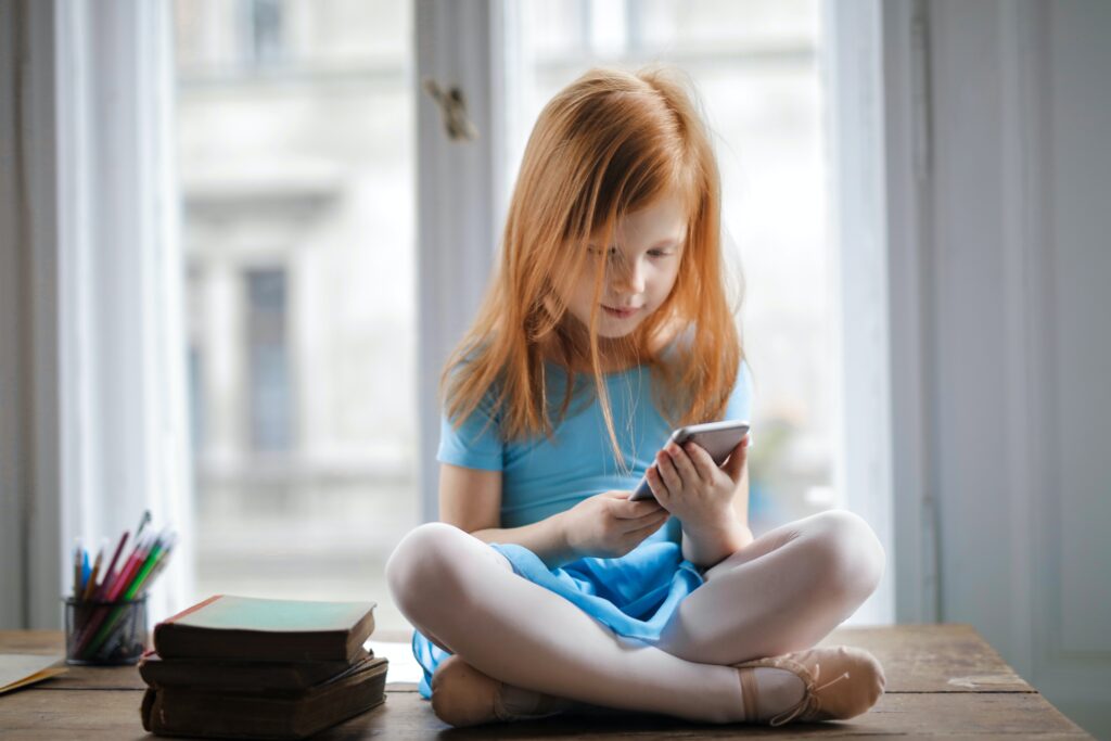 Young girl looking at smartphone
