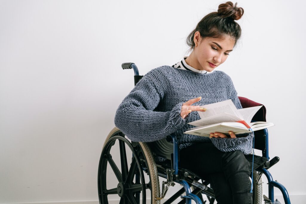 Woman in wheelchair reading book