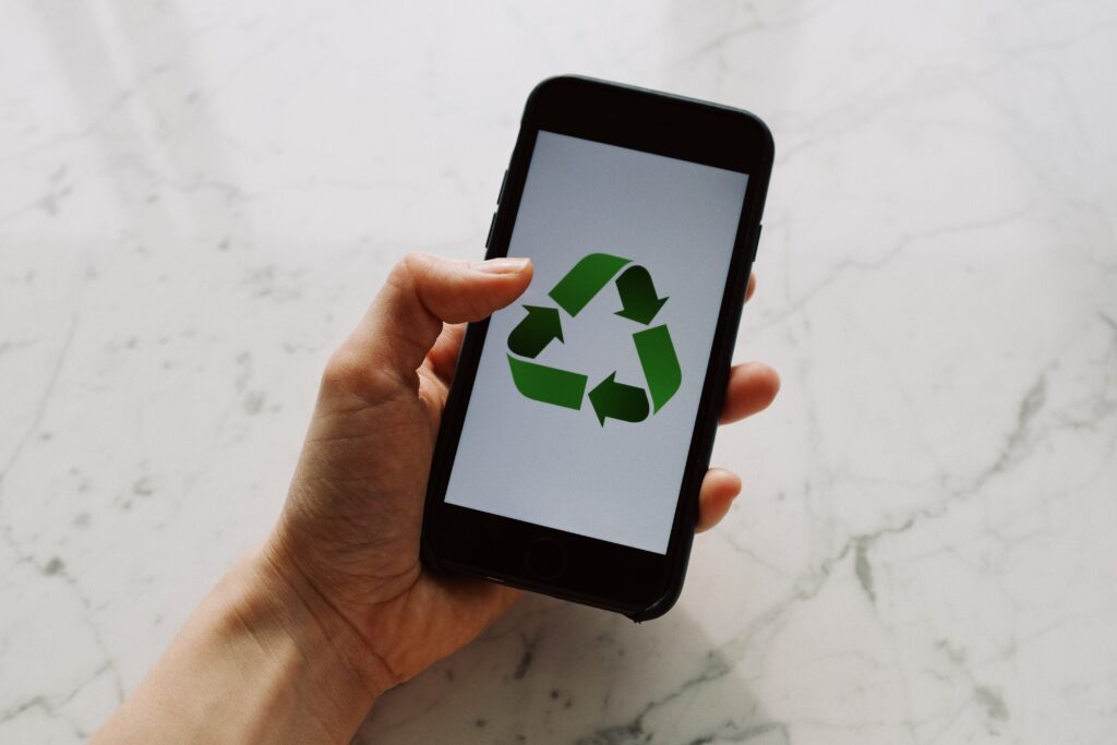 Smartphone with screen showing recycling symbol