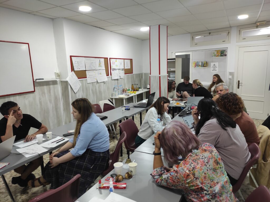 Group work session in classroom with participants discussion in small groups