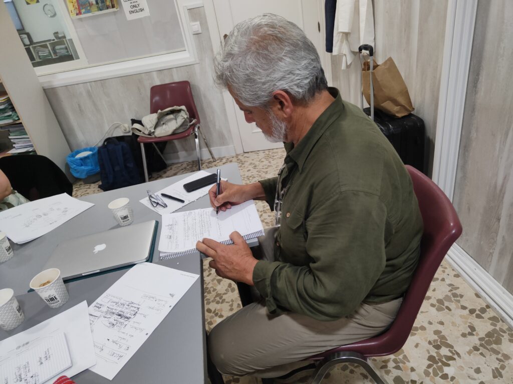 Man sitting in classroom writing